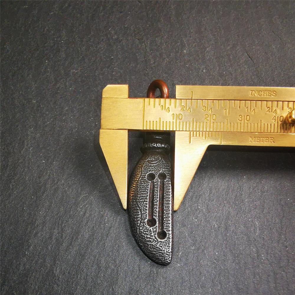 This unique knife pendant is hand carved by Tibetan craftsmen from Tibet in 2000s. It's made of cold iron,inlaid copper wire, black color,size is 2.36" × 0.55“. You can make it into a necklace pendant or key chain.