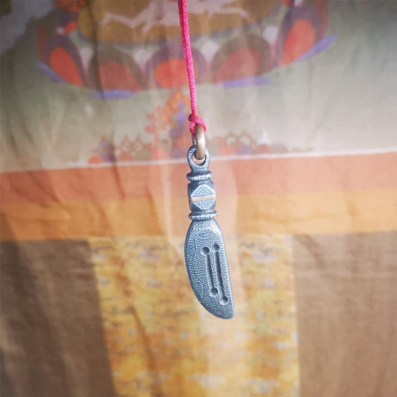 This unique knife pendant is hand carved by Tibetan craftsmen from Tibet in 2000s. It's made of cold iron,inlaid copper wire, black color,size is 2.36" × 0.55“. You can make it into a necklace pendant or key chain.