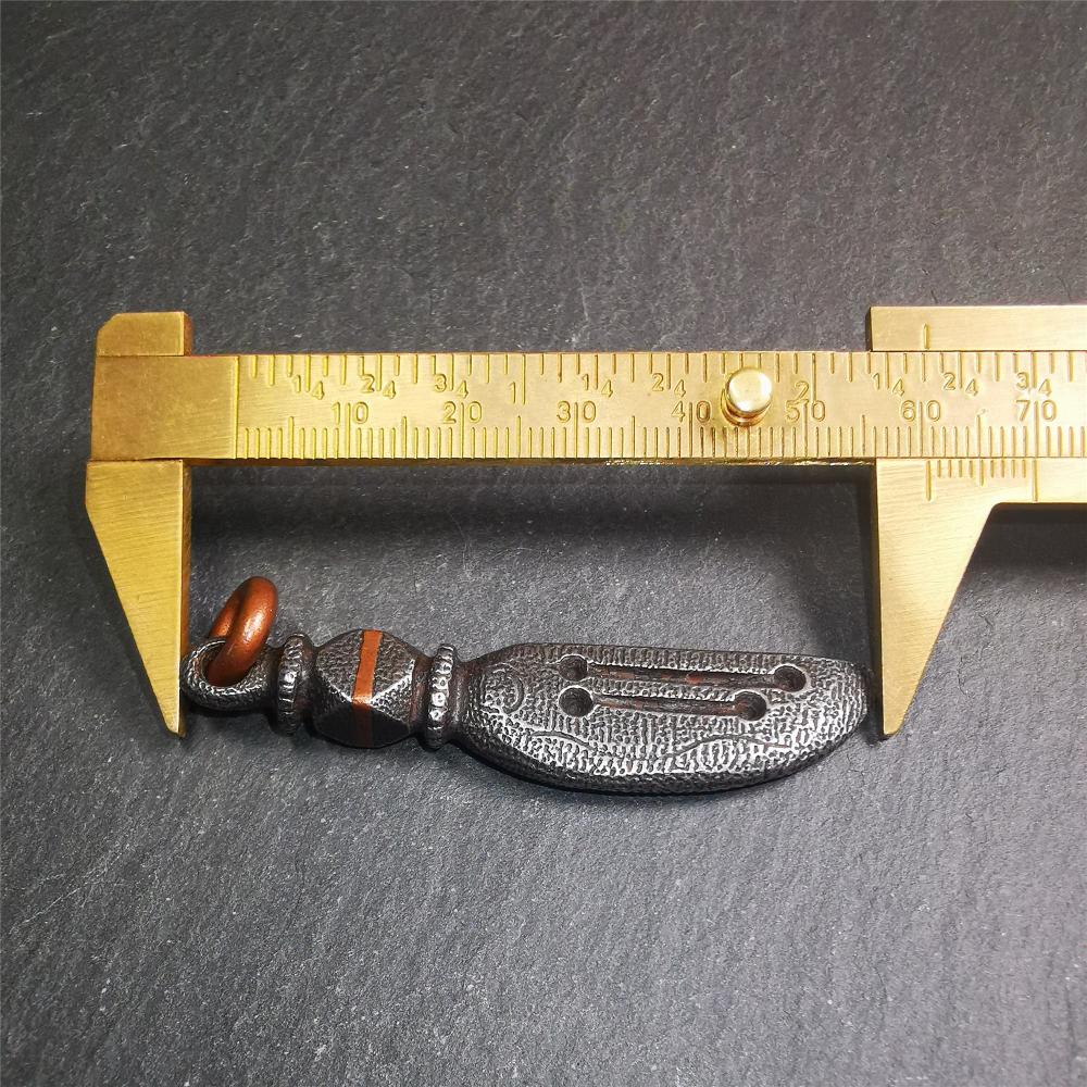 This unique knife pendant is hand carved by Tibetan craftsmen from Tibet in 2000s. It's made of cold iron,inlaid copper wire, black color,size is 2.36" × 0.55“. You can make it into a necklace pendant or key chain.