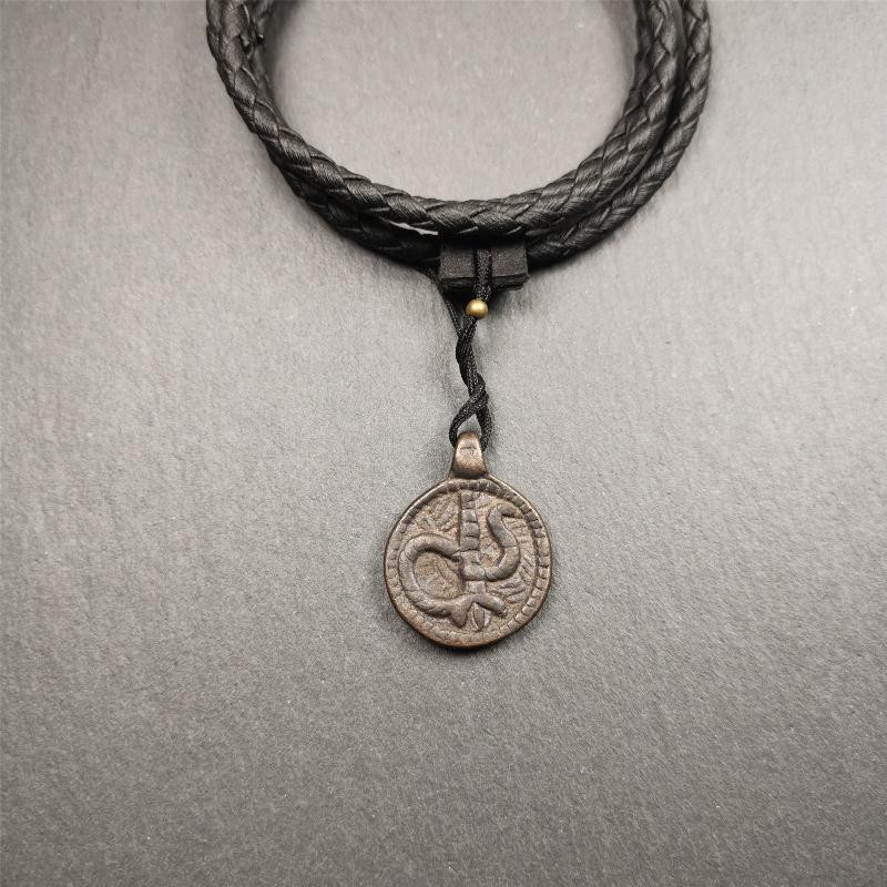 These amulet were handmade by Tibetan craftsmen from Tibet in 1990's. It's made of copper/brass,brown/yellow color,diameter is 0.83 inch,comes with a leather cord. You can make it into a necklace,or bag hanging