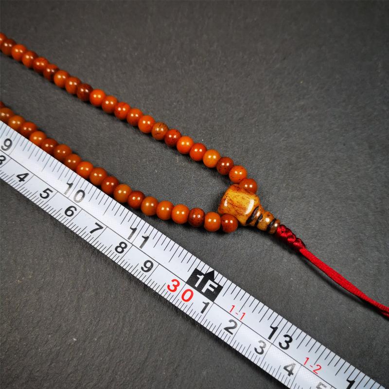This yak bone mala was handmade from tibetan crafts man in Baiyu County,about 30 years old. It's composed of 108 pcs small size 6mm bone beads,with agate and turquoise beads,bone guru bead.Circumference about 61cm,24 inches.