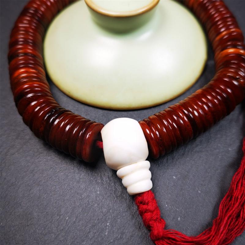 This bone carved mala beads is made by Tibetan craftsmen and come from Hepo Town, Baiyu County,about 30 years Old. It has 108 flat shape beads,1 turquoise spacer bead,and 1 shell guru bead,all hand carved.