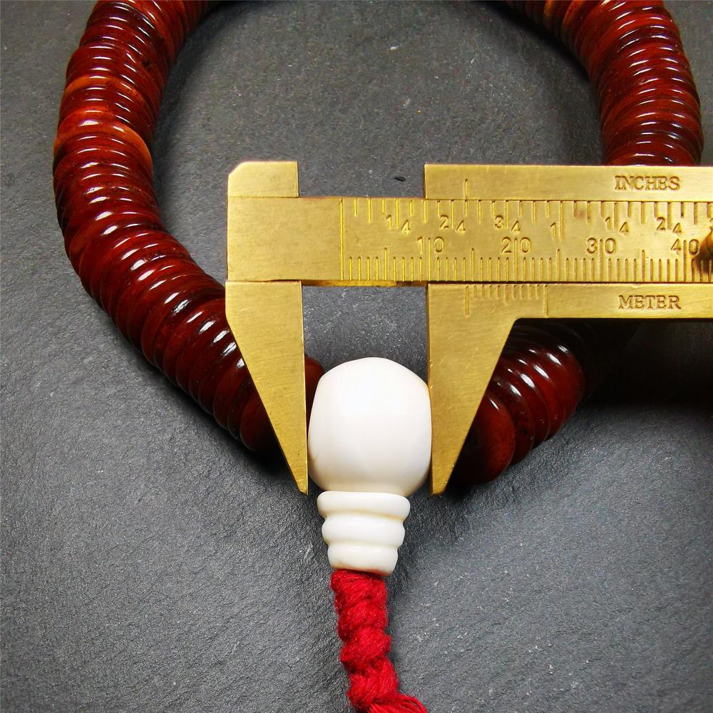 This bone carved mala beads is made by Tibetan craftsmen and come from Hepo Town, Baiyu County,about 30 years Old. It has 108 flat shape beads,1 turquoise spacer bead,and 1 shell guru bead,all hand carved.