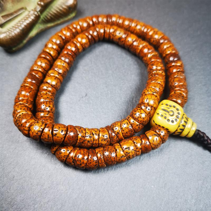 This lotus seed mala was collected from Baiyu county,about 40 years old,hold and blessed by a lama. It is composed of 108 bodhi seed beads, bevel cut shape,brown color,and 1 yak bone guru bead.