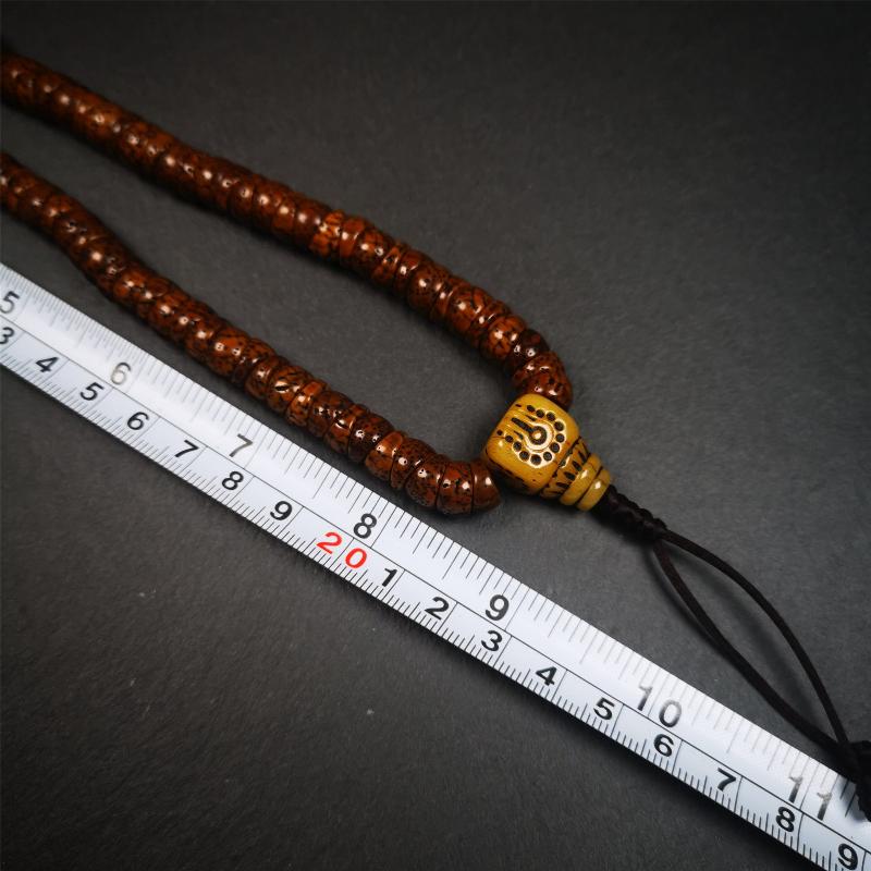 This lotus seed mala was collected from Baiyu county,about 40 years old,hold and blessed by a lama. It is composed of 108 bodhi seed beads, bevel cut shape,brown color,and 1 yak bone guru bead.