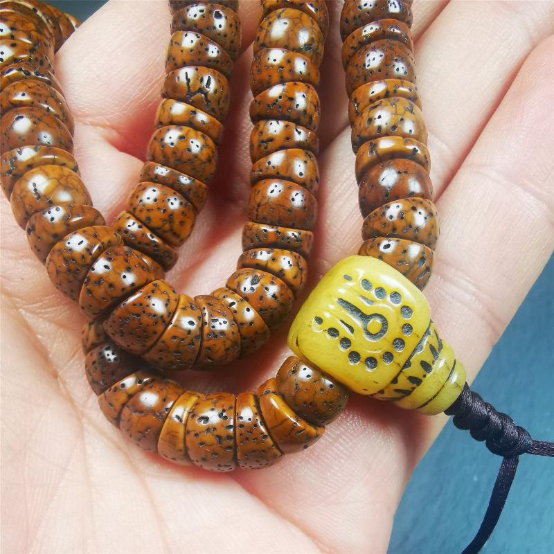 This lotus seed mala was collected from Baiyu county,about 40 years old,hold and blessed by a lama. It is composed of 108 bodhi seed beads, bevel cut shape,brown color,and 1 yak bone guru bead.