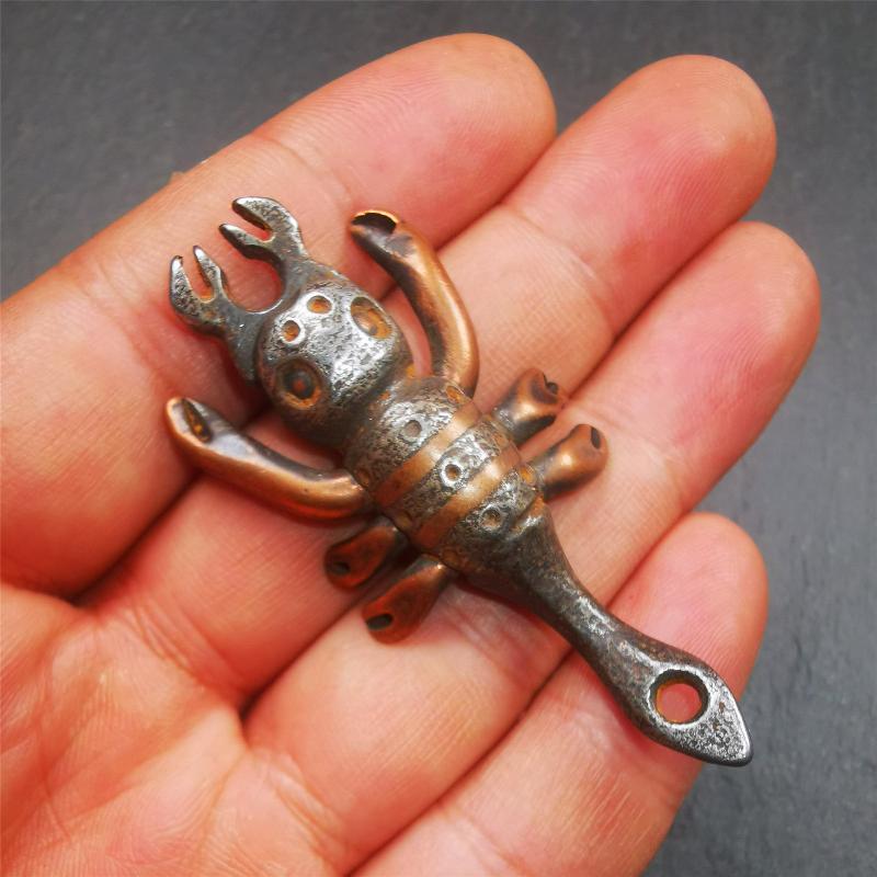 This scorpion is handmade by Tibetan craftsmen in Hepo Township, Baiyu County, the birthplace of the famous Tibetan handicrafts. It is made of cold iron,black color, the shape is scorpion guru (from Guru Rinpoche), use the copper inlaid and carved craftsmanship. The eight legs of this scorpion are carved from copper and are inlaid in a body made of thunder iron,a beautiful pattern on the abdomen of the scorpion, exquisite and beautiful craftsmanship.