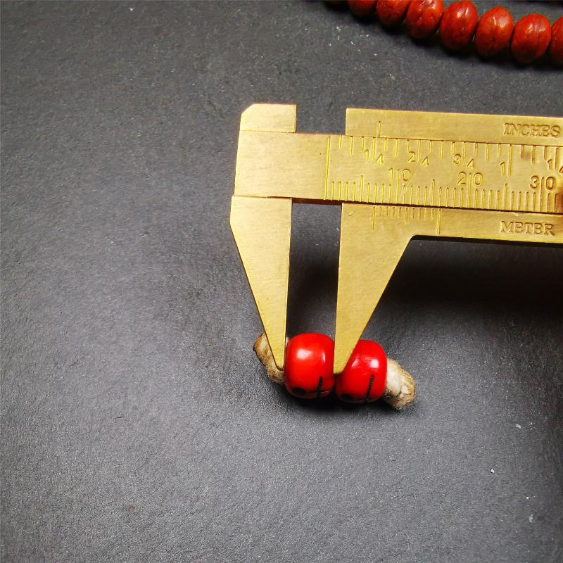 These marker beads were handmade by Tibetan craftsmen and come from Hepo Town, Baiyu County, the birthplace of the famous Tibetan handicrafts. It is made of plastic,carved skull pattern,red color,size is 0.4" × 0.3".