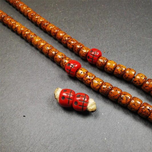 These marker beads were handmade by Tibetan craftsmen and come from Hepo Town, Baiyu County, the birthplace of the famous Tibetan handicrafts. It is made of plastic,carved skull pattern,red color,size is 0.4" × 0.3".