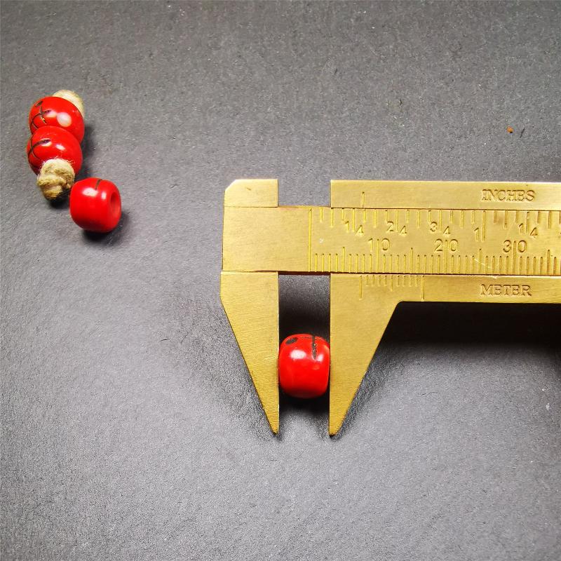 These marker beads were handmade by Tibetan craftsmen and come from Hepo Town, Baiyu County, the birthplace of the famous Tibetan handicrafts. It is made of plastic,carved skull pattern,red color,size is 0.4" × 0.3".