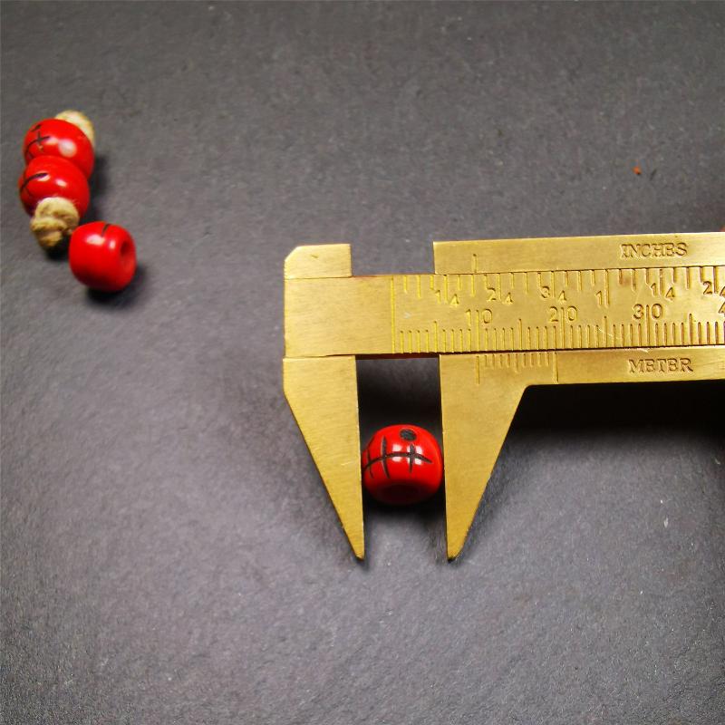 These marker beads were handmade by Tibetan craftsmen and come from Hepo Town, Baiyu County, the birthplace of the famous Tibetan handicrafts. It is made of plastic,carved skull pattern,red color,size is 0.4" × 0.3".