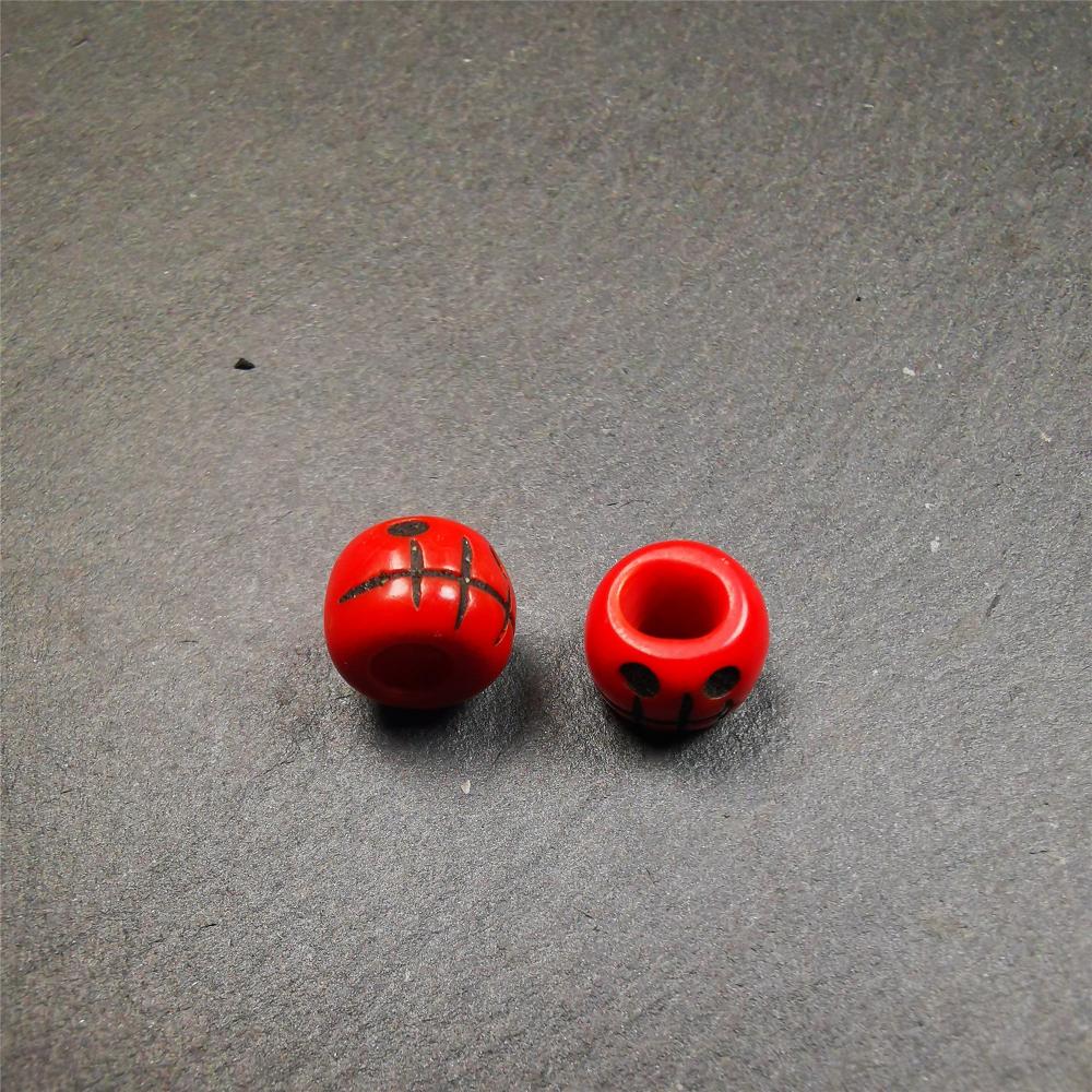 These marker beads were handmade by Tibetan craftsmen and come from Hepo Town, Baiyu County, the birthplace of the famous Tibetan handicrafts. It is made of plastic,carved skull pattern,red color,size is 0.4" × 0.3".