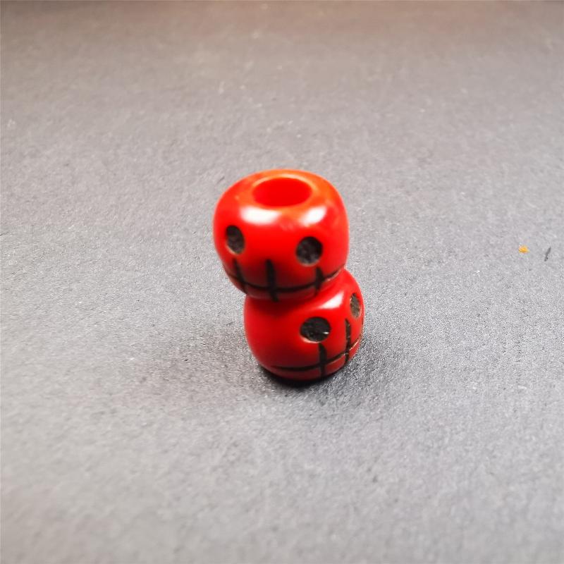 These marker beads were handmade by Tibetan craftsmen and come from Hepo Town, Baiyu County, the birthplace of the famous Tibetan handicrafts. It is made of plastic,carved skull pattern,red color,size is 0.4" × 0.3".