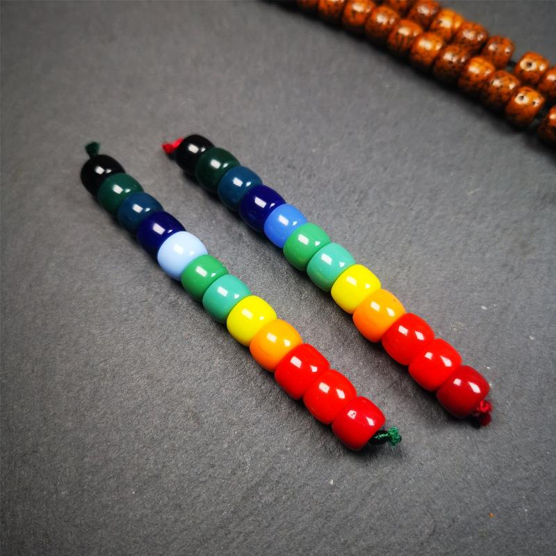 The price is 1 pair of 2 Strings Sherpa Glaze Beads,total 24 beads.(each string 12 beads) These marker beads were handmade by Tibetan craftsmen and come from Hepo Town, Baiyu County, the birthplace of the famous Tibetan handicrafts. It is made of sherpa glaze,rainbow color,size is 0.31" × 0.24". Fit for 6-8mm mala (The reference in the photo is 8mm lotus seed mala)