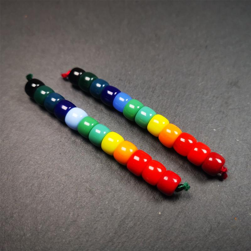 The price is 1 pair of 2 Strings Sherpa Glaze Beads,total 24 beads.(each string 12 beads) These marker beads were handmade by Tibetan craftsmen and come from Hepo Town, Baiyu County, the birthplace of the famous Tibetan handicrafts. It is made of sherpa glaze,rainbow color,size is 0.31" × 0.24". Fit for 6-8mm mala (The reference in the photo is 8mm lotus seed mala)