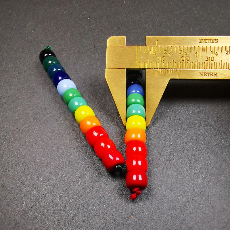 The price is 1 pair of 2 Strings Sherpa Glaze Beads,total 24 beads.(each string 12 beads) These marker beads were handmade by Tibetan craftsmen and come from Hepo Town, Baiyu County, the birthplace of the famous Tibetan handicrafts. It is made of sherpa glaze,rainbow color,size is 0.31" × 0.24". Fit for 6-8mm mala (The reference in the photo is 8mm lotus seed mala)
