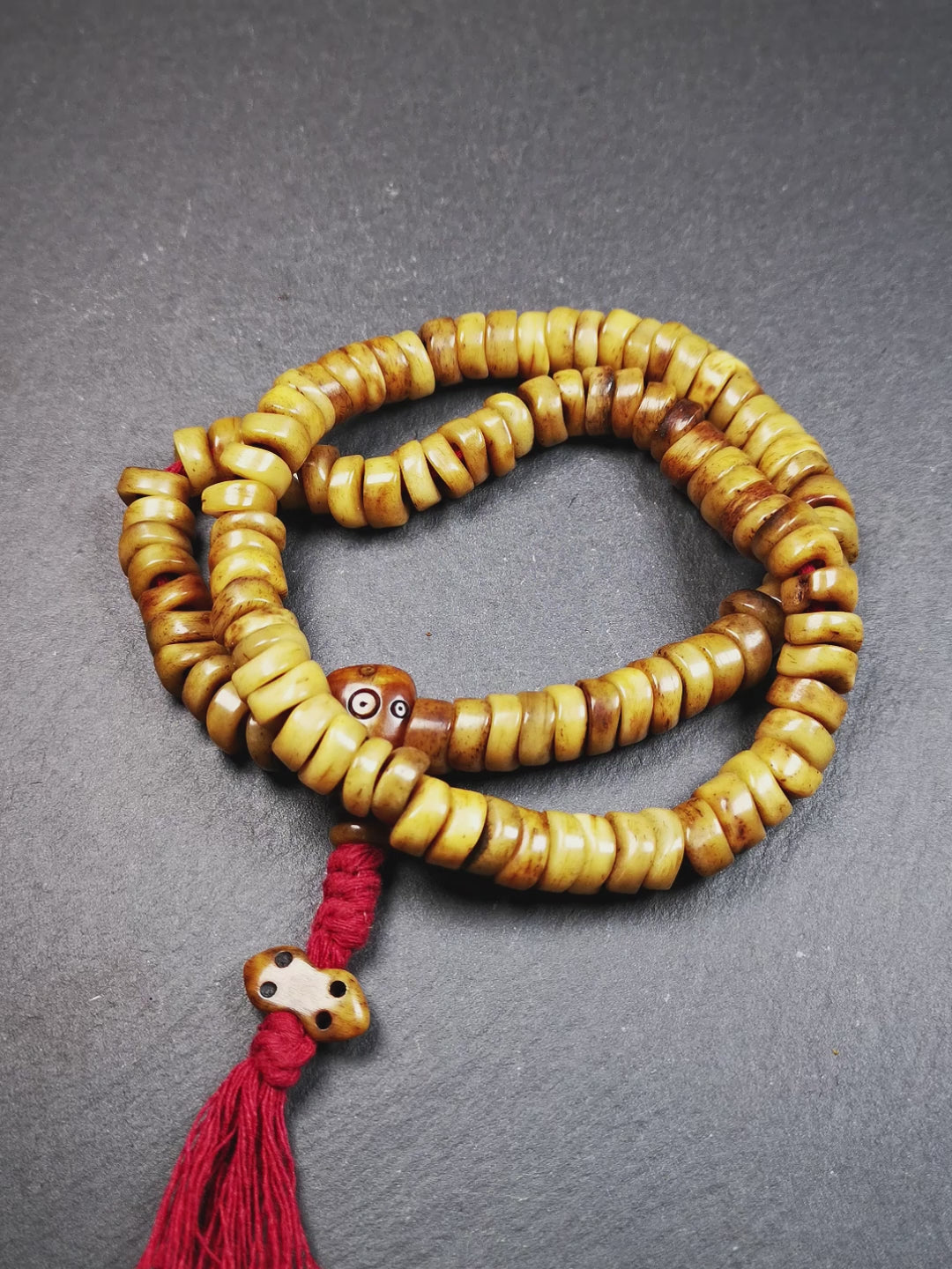 This unique wave shape mala was made by Tibetan craftsmen and come from Hepo Town, Baiyu County, the birthplace of the famous Tibetan handicrafts,about 30 years old. It is made of yak bone, yellow color,108 wave shape beads diameter of 10mm / 0.4",circumference is 48cm / 18.9", end of bone guru bead and vajra pendant. It reflects the original ascetic state of the original ecology, very simple and full of sense of time