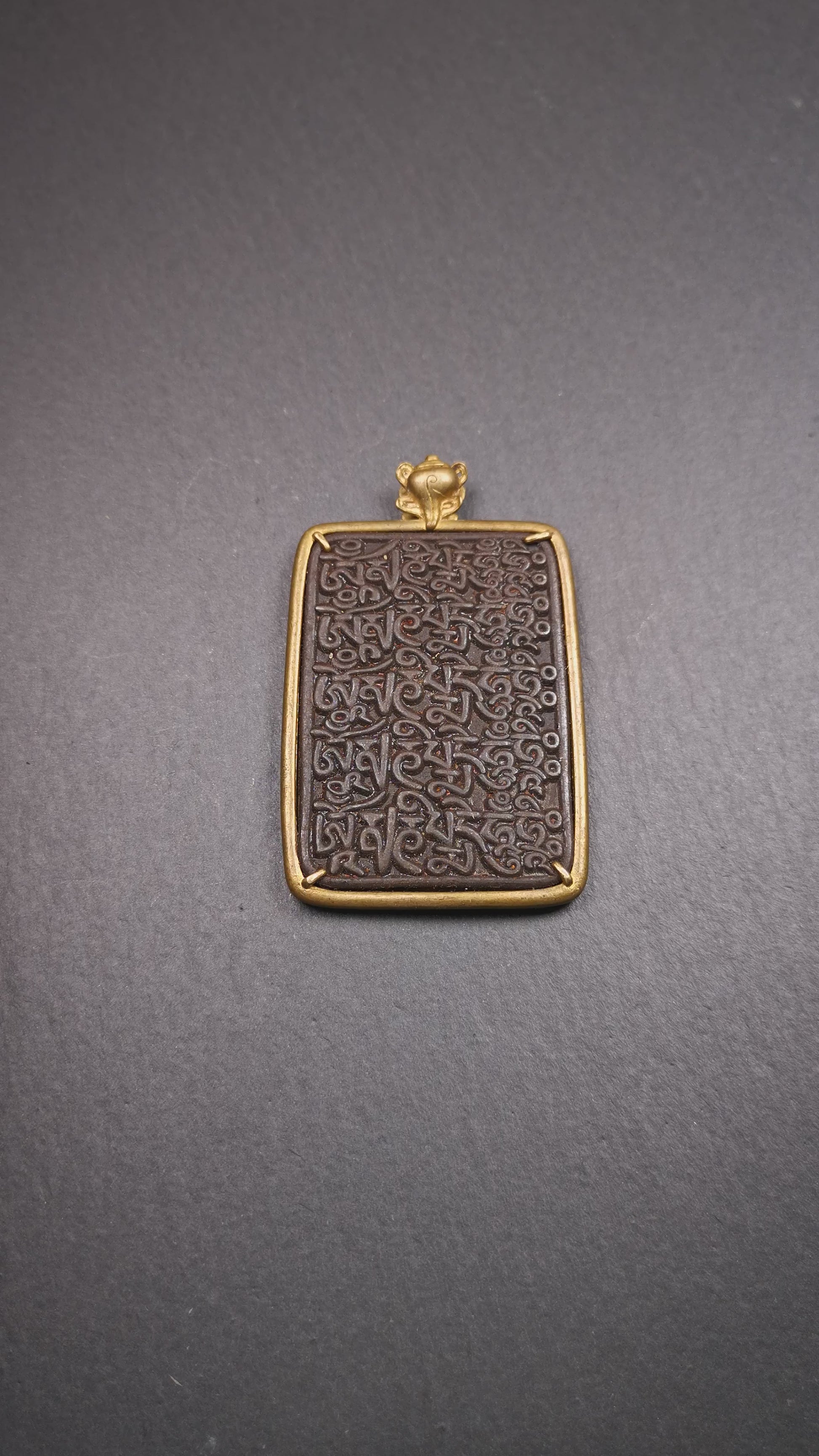 This badge is made by Tibetan craftsmen from Hepo Town, Baiyu County, the birthplace of the famous Tibetan handicrafts. It is made of thokcha, edging with copper, 2.76 × 1.77". The front is the OM mantra and the back is body, speech, and mind.