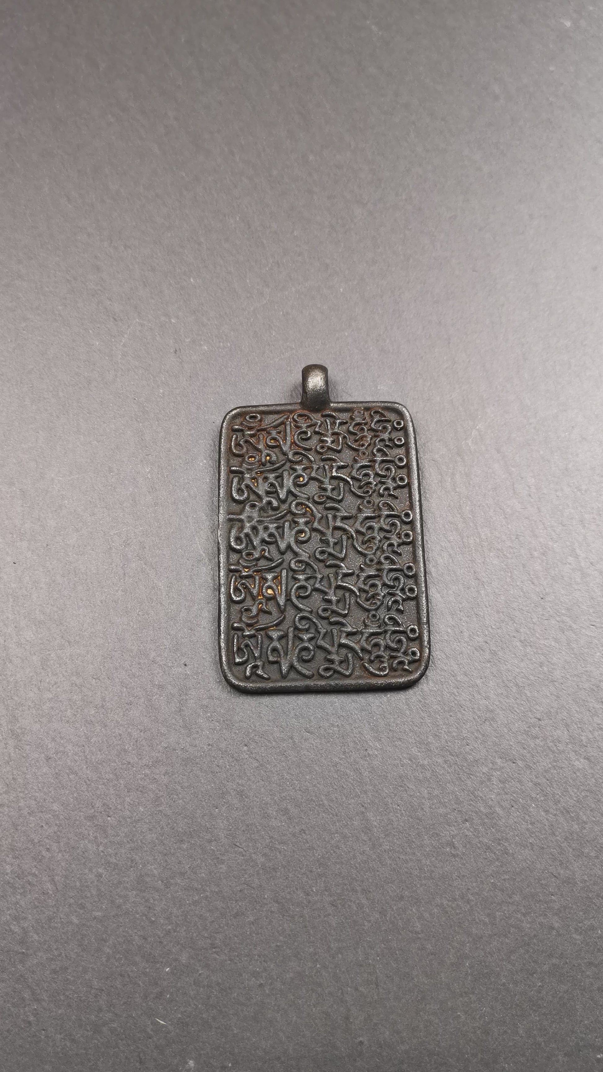 This badge is made by Tibetan craftsmen from Hepo Town, Baiyu County, the birthplace of the famous Tibetan handicrafts. It is made of copper, 2.52 × 1.57 inches. The front is the OM mantra and the back is body, speech, and mind.