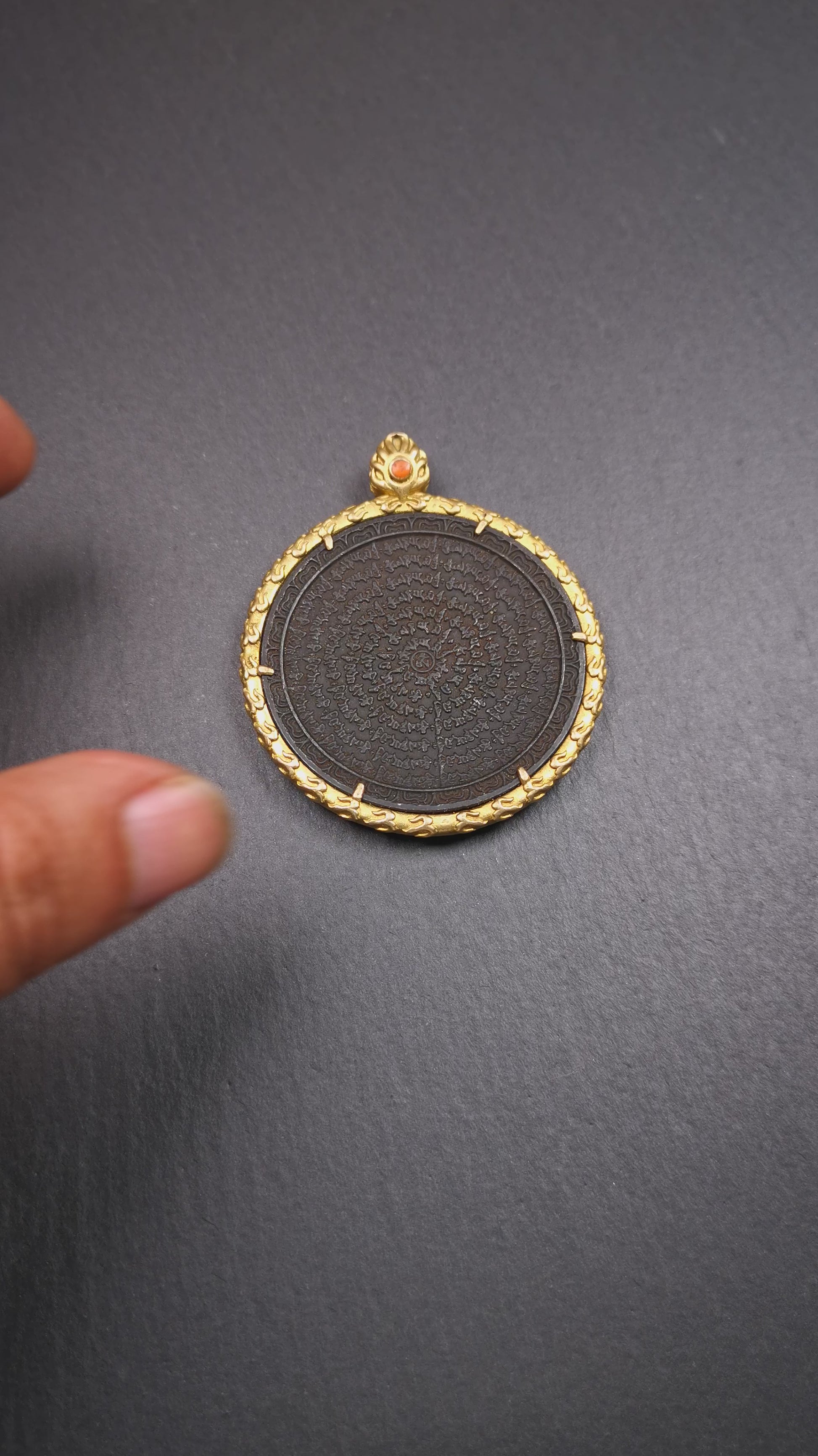 This badge is made by Tibetan craftsmen and come from Hepo Town, Baiyu County,Tibet. It is made of thokcha, edging with copper,round shape, 2.52 inche diameter. The OM MANI PADME HUM mantra arranged in concentric circles.