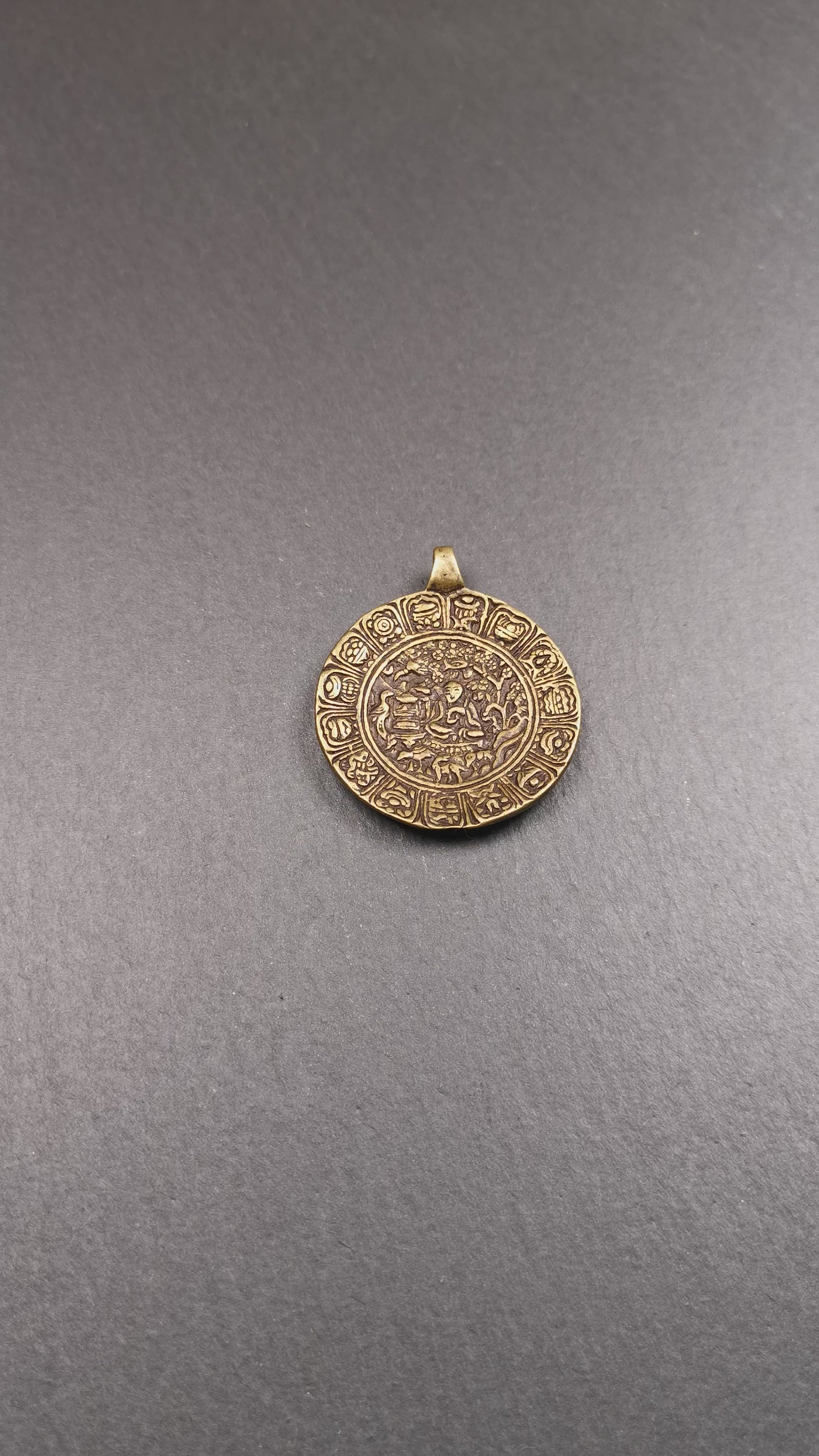This Longevity Badge was handmade by Tibetan craftsmen and come from Hepo Town, Baiyu County, Tibet. It is made of brass,round shape,the theme is the god of longevity,surrounded by the symbols of Ashtamangala.