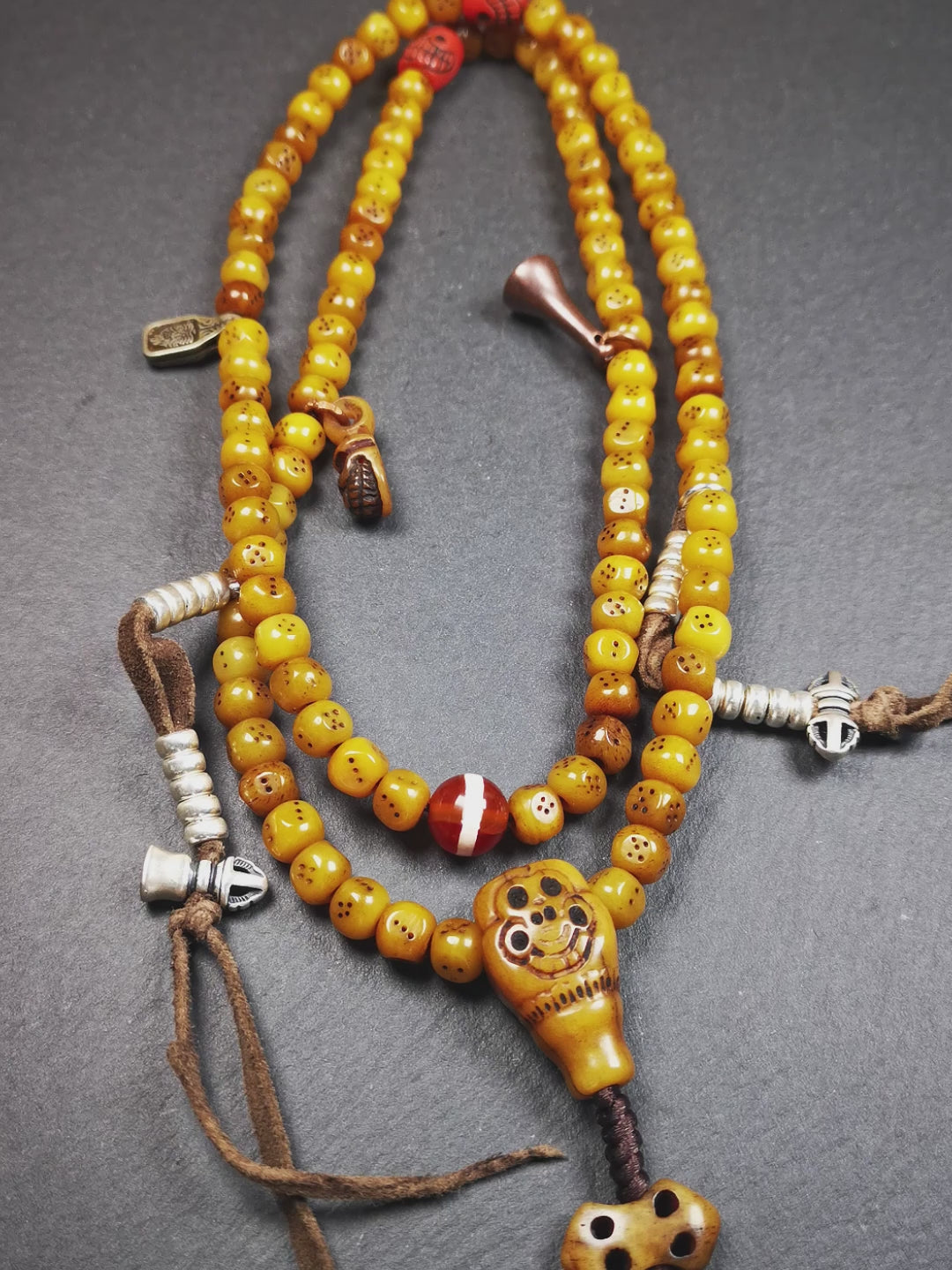 This mala bracelet was made by Tibetan craftsmen. It is made of yak bone, yellow color,108 dice beads diameter of 7mm / 0.27",circumference is 68cm / 26.8",and lots of accessories on it.