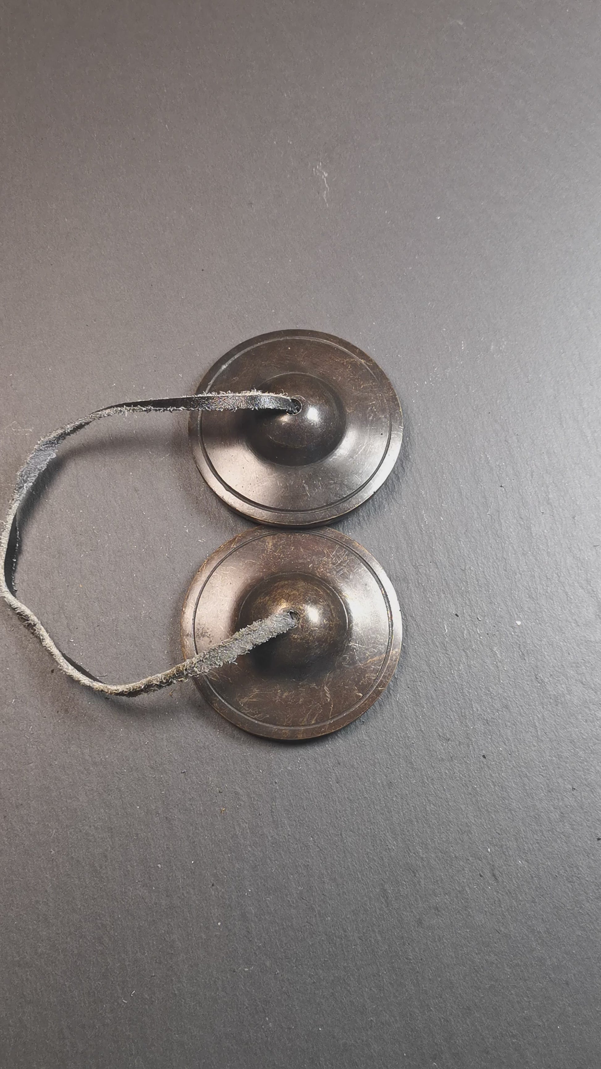 This tingsha bell set was handmade in Nepal,using traditional techniques and materials. It was made of brass,dark color,6.5cm diameter,with pure, clear and resonant,good for meditation. Come with tingsha case.