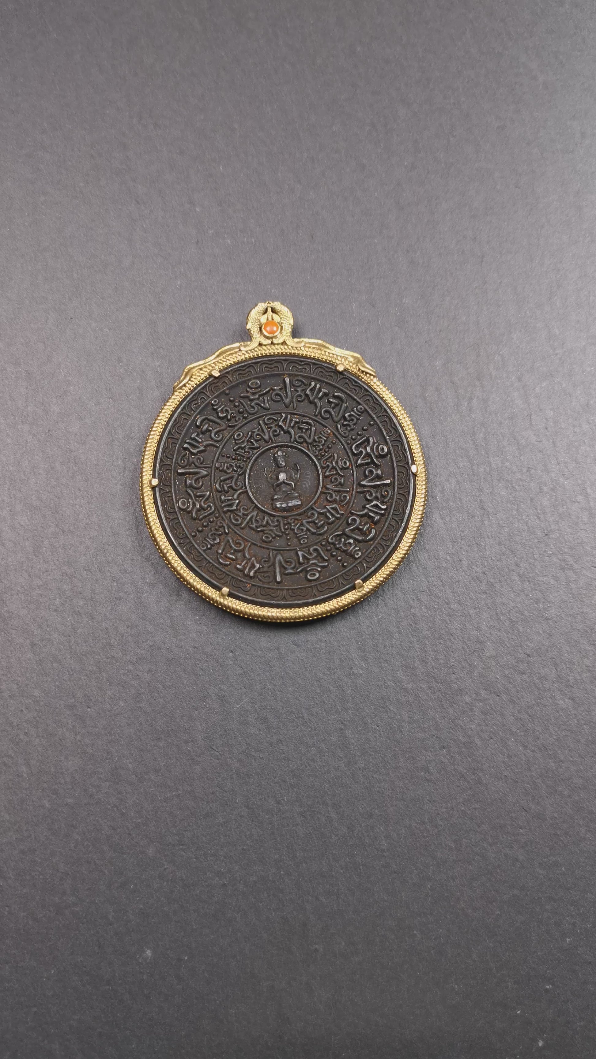 This badge was made by Tibetan craftsmen and come from Hepo Town, Baiyu County,Tibet. It is made of thokcha, edging with copper, 2.1 diameter. The mantra Om Mani Padme Hum is arranged in concentric circles around the chenrezig.