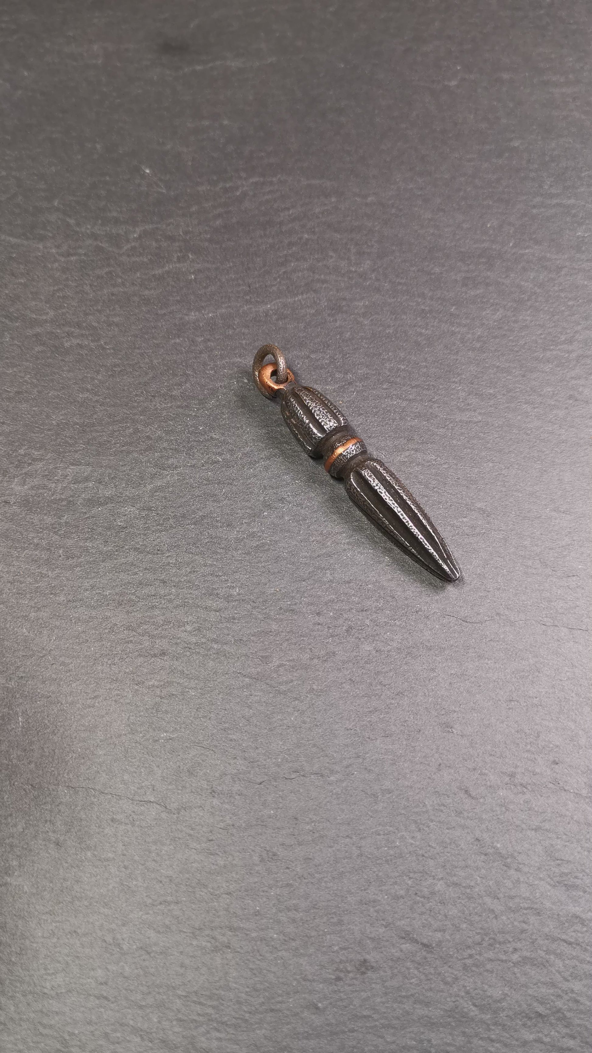 This handmade Dorje Phurba was crafted by Tibetan craftsmen from Hepo Town, Baiyu County, Tibet. The length is 2.5 inches,black color,the upper part is a vajra, and the lower part is a phurba. A copper wire is inlaid on the waist of the phurba.