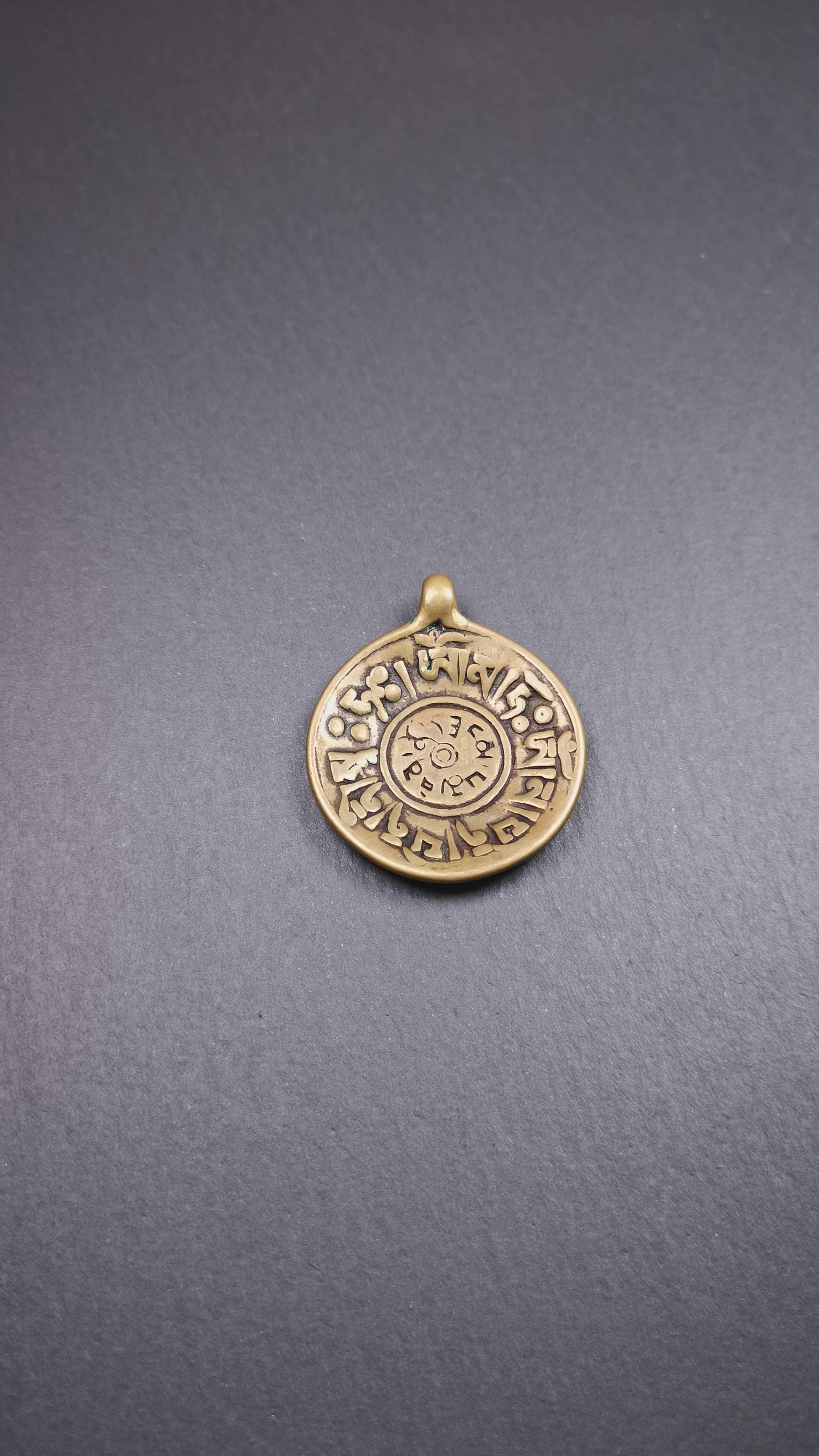 This Om badge amulet was collected from Yushu City Tibet,about 50 years old. It is round shape,made of lima brass, 1.65 inches,carved with mantra of chenrezig OM MANI PADME HUM. You can make it into a necklace, or a keychain, pendant