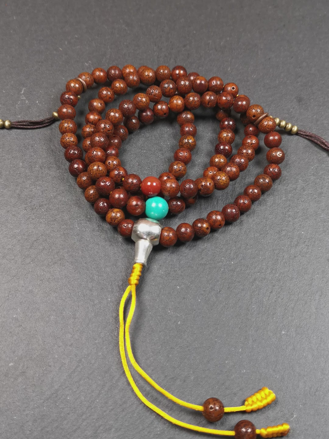 This old lotus seed mala was handmade from tibetan crafts man in Baiyu County,about 30 years old,blessed by lama. It's composed of 108 pcs 8mm lotus seed beads,then add some old agate,turquoise beads,1 pair of copper bead counters,and white copper guru bead on it.