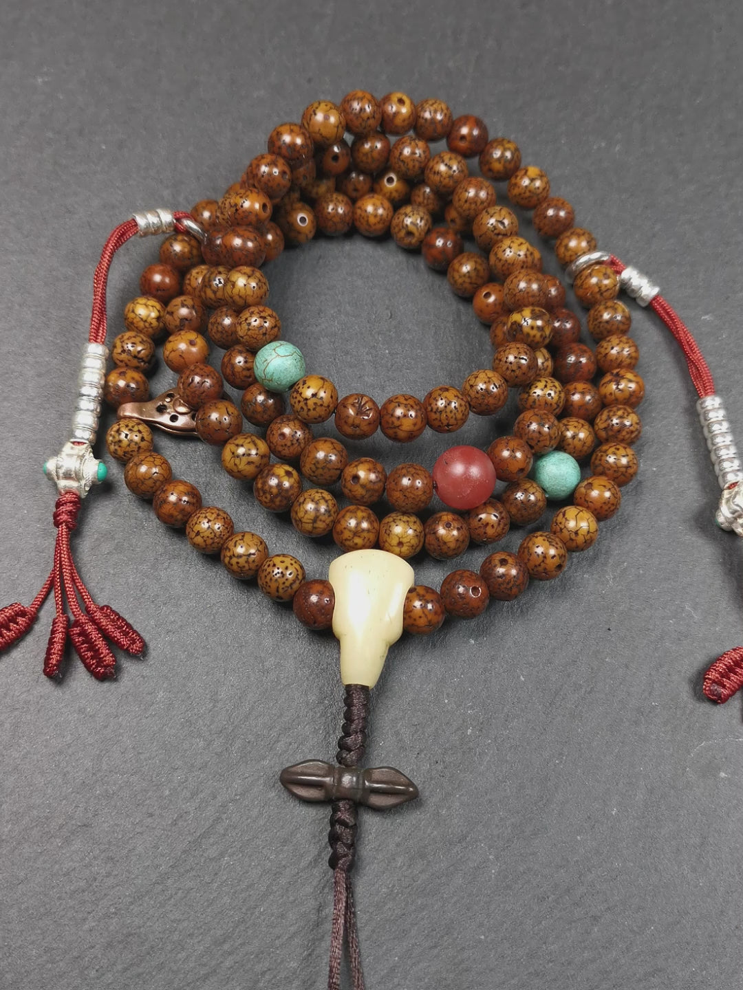 This old lotus seed mala was handmade from tibetan crafts man in Baiyu County,about 30 years old. It's composed of 108 pcs 7mm lotus seed beads,then add some old agate,turquoise beads,1 pair of silver bead counters,and bone guru bead on it.