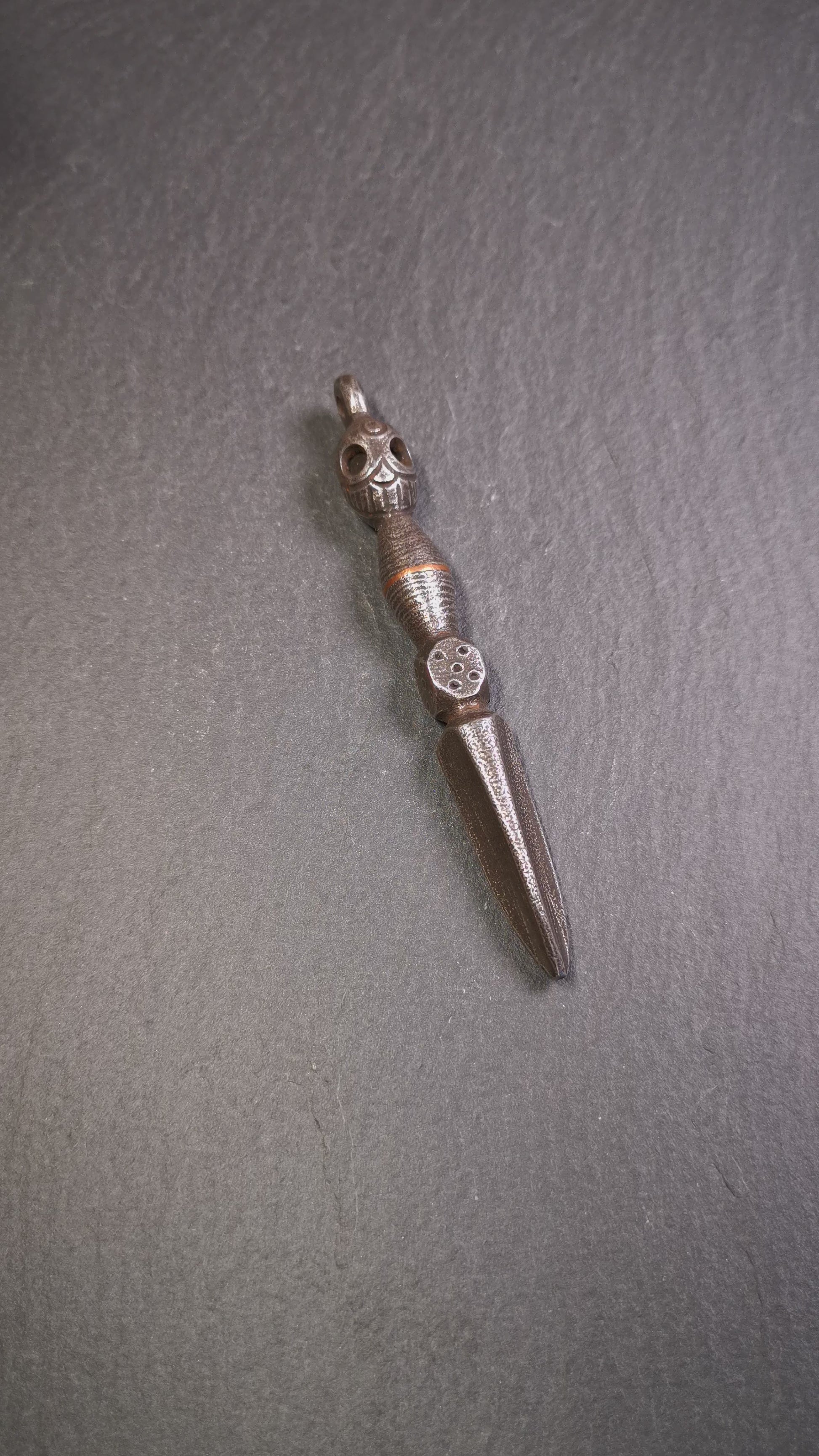 This phurba was made by Tibetan craftsmen and come from Hepo Town, Baiyu County, the birthplace of the famous Tibetan handicrafts. Its upper part is Shmashana Adhipati skull, the lower part is a Dorje Phurba,a dice in the middle,very delicate.