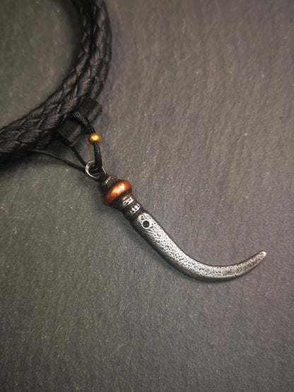 This wolf tooth pendant is made by Tibetan craftsmen and come from Hepo Town, Baiyu County, the birthplace of the famous Tibetan handicrafts. It's made of cold iron and inlaid copper,the body is black color,length is 1.77 inches. You can make it a necklace or mala pendant, or keychain.