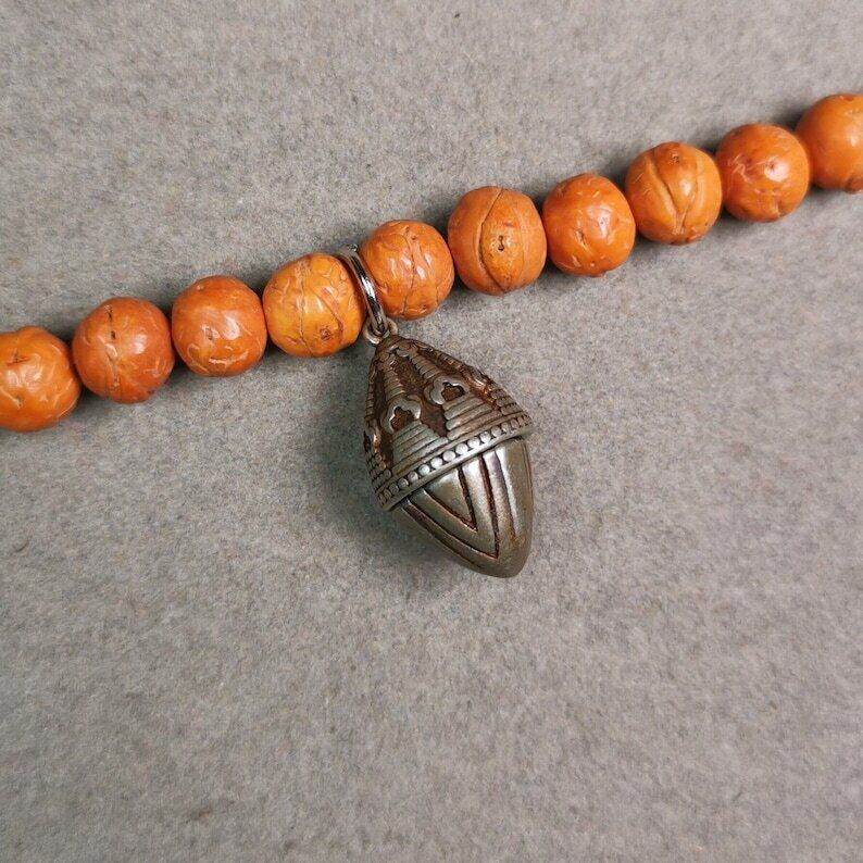 Mala Pendant,Niangla Tsa Tsa Stupa Gau Shrine Amulet - Tibetan Buddhist mala beads, close-up detail