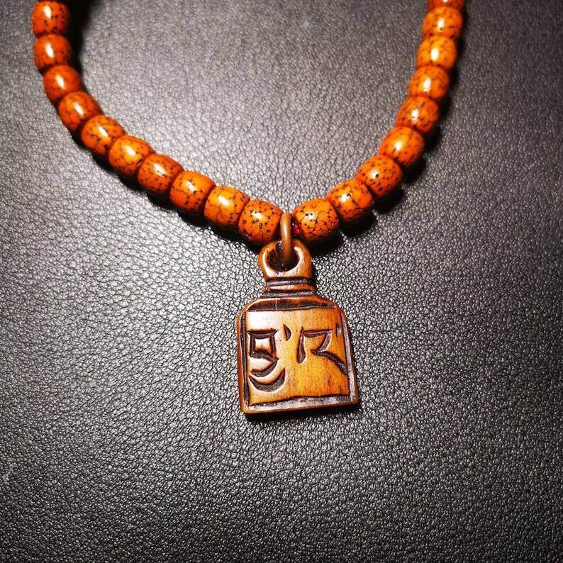 Yak Bone Carved Letter Prayer Bead Pendant - Tibetan Buddhist art, close-up detail