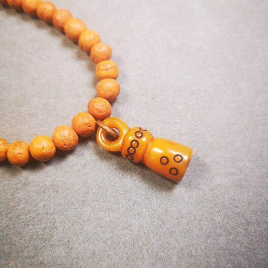 Yak Bone Carved Seal Amulet, Swastika Pattern Stamp Pendant - Tibetan Buddhist amulet, front view