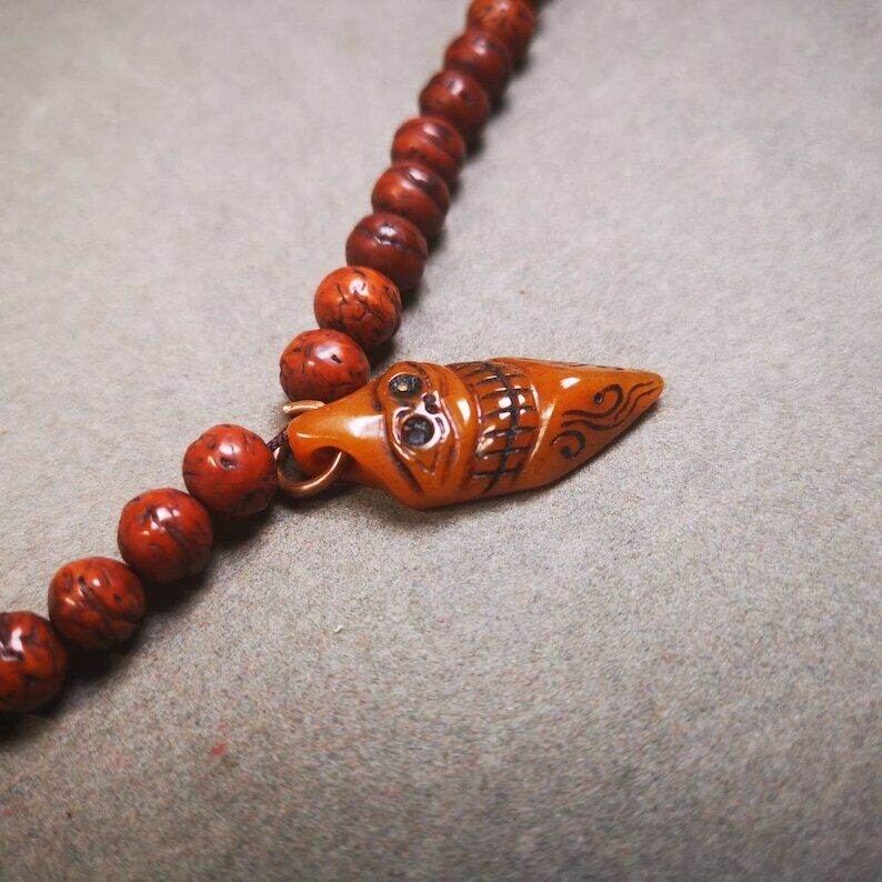 Amulet,Skull Vajra Kila Dorje Phurba Pendant - Tibetan Buddhist amulet, close-up detail