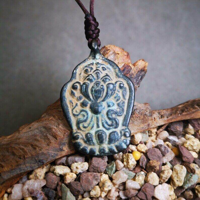 Buddhist Amulet,Lotus Pendant Badge - Tibetan Buddhist amulet, close-up detail