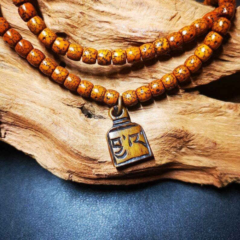 Yak Bone Carved Letter Prayer Bead Pendant - Tibetan Buddhist art, detailed view
