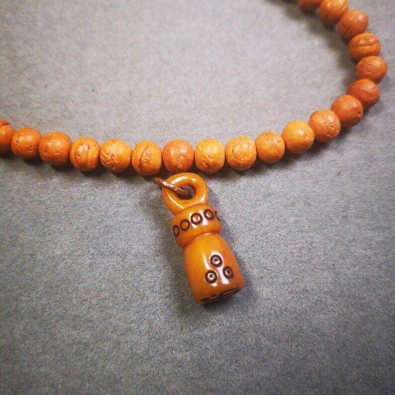 Yak Bone Carved Seal Amulet, Swastika Pattern Stamp Pendant - Tibetan Buddhist amulet, close-up detail