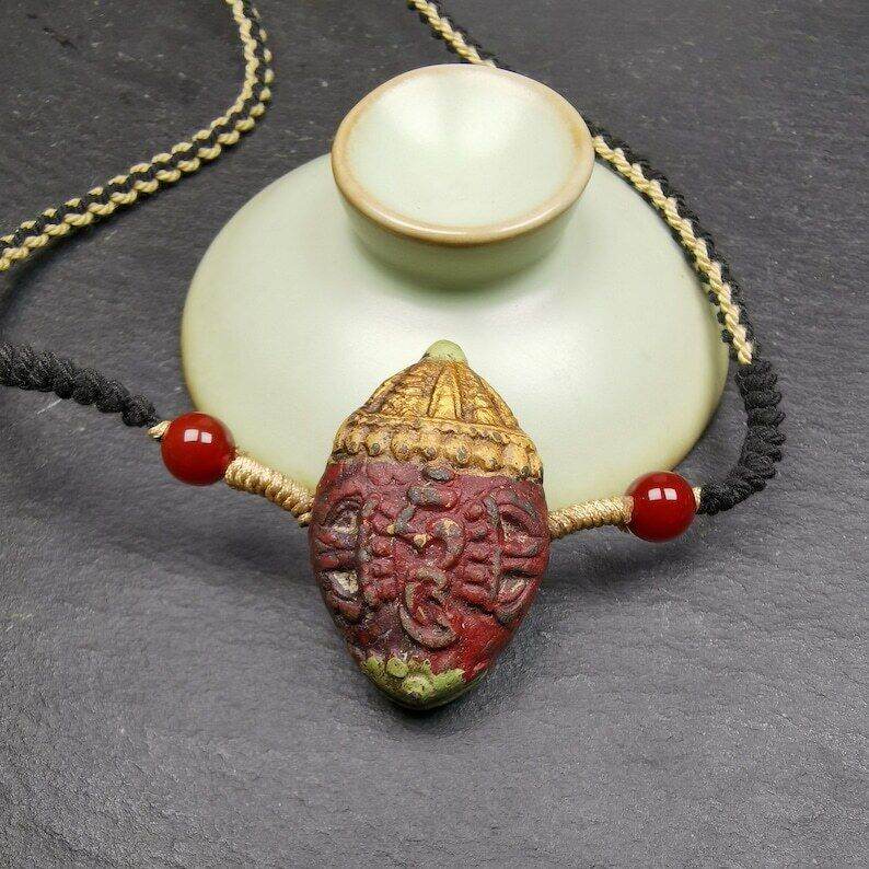 Tibetan Stupa Tsa Tsa Amulet, Double-sided Vajra and Bodhi Leaf Shape Pendant - Tibetan Buddhist amulet, close-up detail