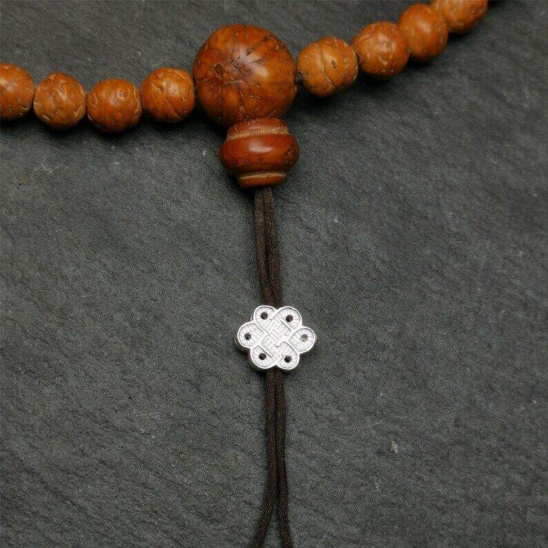 Mala Bead Pendant,Sterling Silver Lucky Knot Bead,Endless Knot - Tibetan Buddhist mala beads, close-up detail