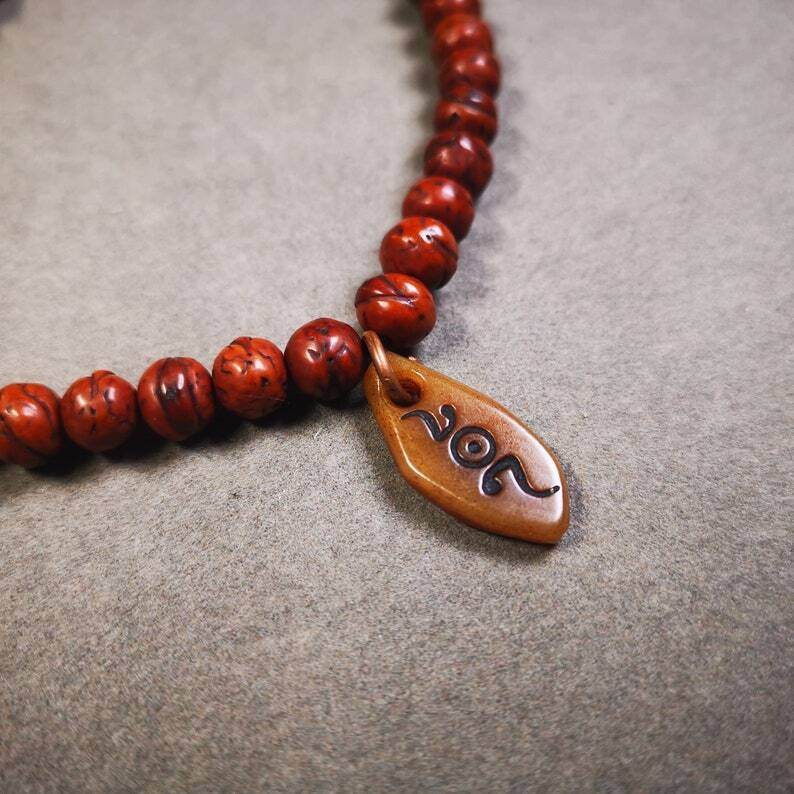 Yak Bone Carved Mani Jewel Prayer Bead Pendant - Tibetan Buddhist art, close-up detail