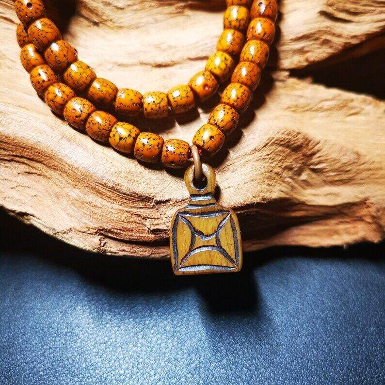 Yak Bone Carved Letter Prayer Bead Pendant - Tibetan Buddhist art, detailed view