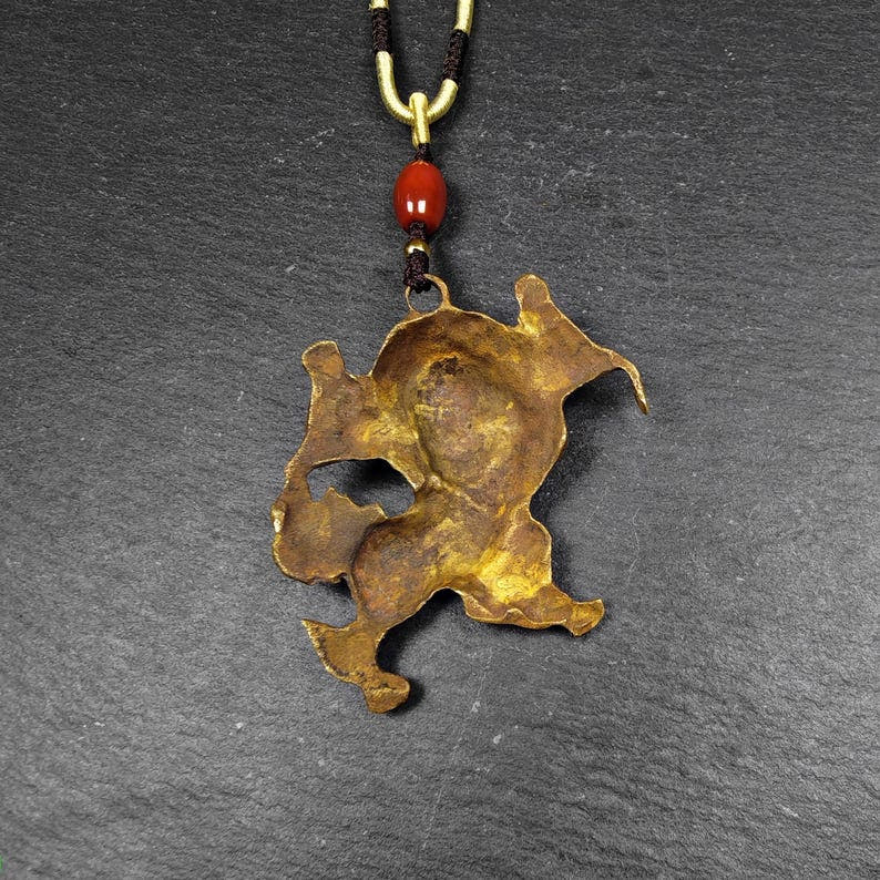 Authentic Tibetan Snow Lion Amulet - Tibetan Buddhist amulet, close-up detail