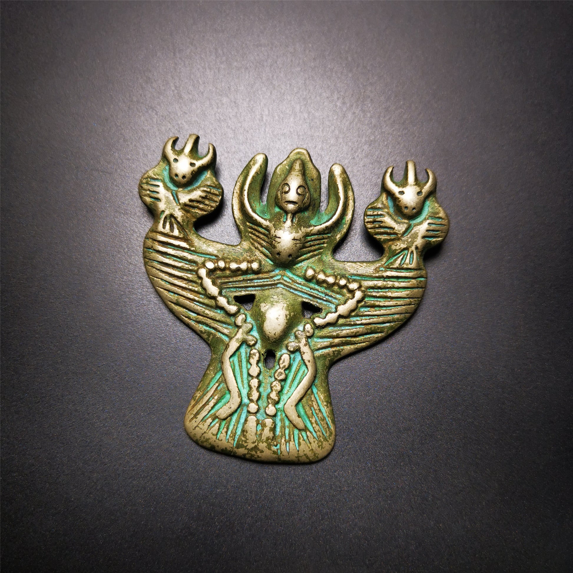 This Garuda is collected from Yaqing Monastery Baiyu County Tibet,it's a handmade badge,amulet pandent, made of copper,about 80 years old.  You can wear it as amulet pendant, or make it into wall decoration, hang on the door as a protector,or just put it on your desk,as an ornament.
