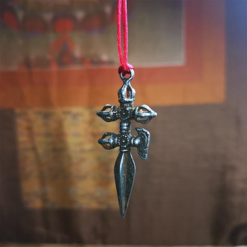 This beautiful phurba pendant is hand carved by Tibetan craftsmen from Tibet in 1980,Its upper part is a horizontal vajra and a kartika, the lower part is a longitudinal, phurba, the whole is made of thokcha, the size is 2.36" by 0.98"