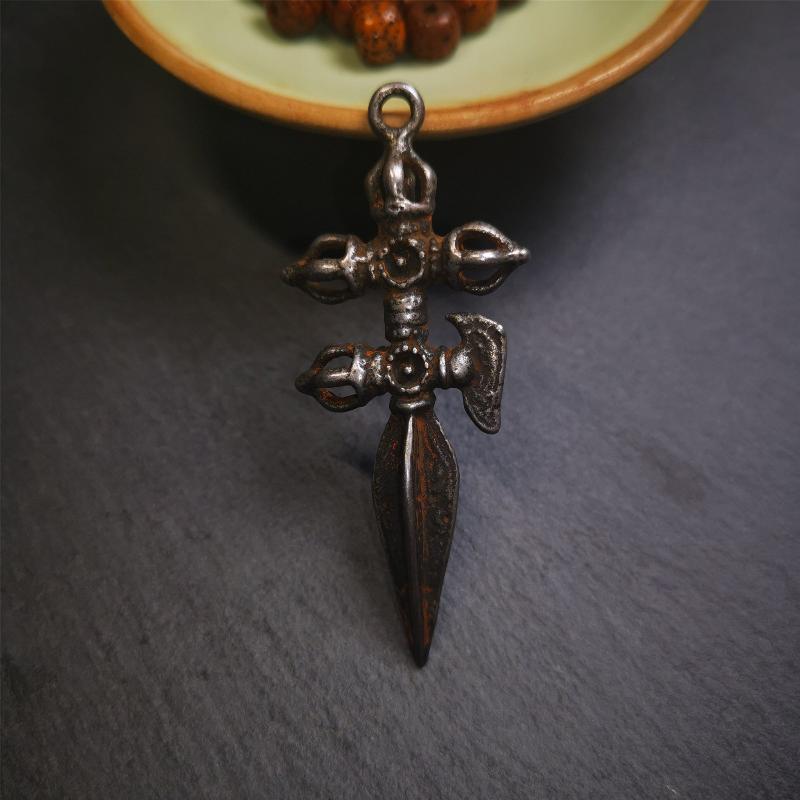 This beautiful phurba pendant is hand carved by Tibetan craftsmen from Tibet in 1980,Its upper part is a horizontal vajra and a kartika, the lower part is a longitudinal, phurba, the whole is made of thokcha, the size is 2.36" by 0.98"