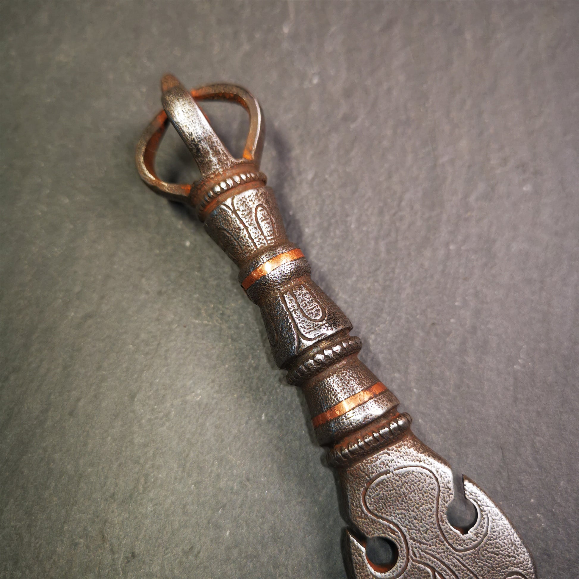 This phurba kila is handmade by Tibetan craftsmen from Tibet in 2000's,from Hepo Town, Baiyu County, the birthplace of the famous Tibetan handicrafts.  It's a kila dagger,made of cold iron, carved cloud pattern, inlaid red copper, and the half vajra on the handle,very delicate.